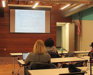Neighbors | Jessica Harker .Youngstown State University Director of Entrepreneurship Center Joseph Angelo visited community members at the Michael Kusalaba library to discuss the best ways to create a business plan on Jan. 31.