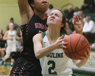 William D. Lewis The Vindicator   Ursuline'sRachel Fabry(2) drives past Struthers' Trinity McDowell(23).