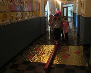 Neighbors | Jessica Harker .Students balanced on a beam trying to cross the golden river on Feb. 14 on their way home from Valentine Land on Feb. 14.