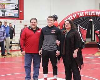 Neighbors | Abby Slanker.Canfield High School senior wrestler Tyler Stein was escorted by his parents during Senior Night on Feb. 13.