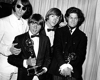 The Monkees pose with their Emmy award at the 19th Annual Primetime Emmy Awards in Calif. on June 4, 1967.  They won for best comedy series and best comedy direction for their television program "The Monkees."  The group members are, from left to right, Mike Nesmith, Davy Jones, Peter Tork, and Micky Dolenz.  (AP Photo)