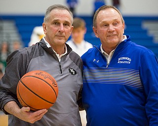 West Branch's Head Coach Randy Montgomery, left, received the game ball from his brother and Hubbard Athletic Director Chuck Montgomery after his 600th victory during their game at Hubbard on Friday night. EMILY MATTHEWS | THE VINDICATOR
