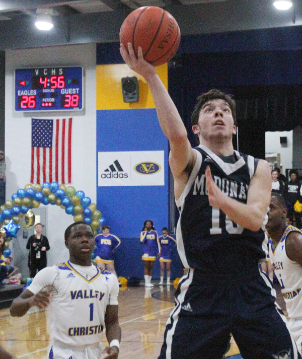 William D. Lewis The Vindicator  McDonald's Josh Celli(10) scores past Valley's Lohron Brown(1).