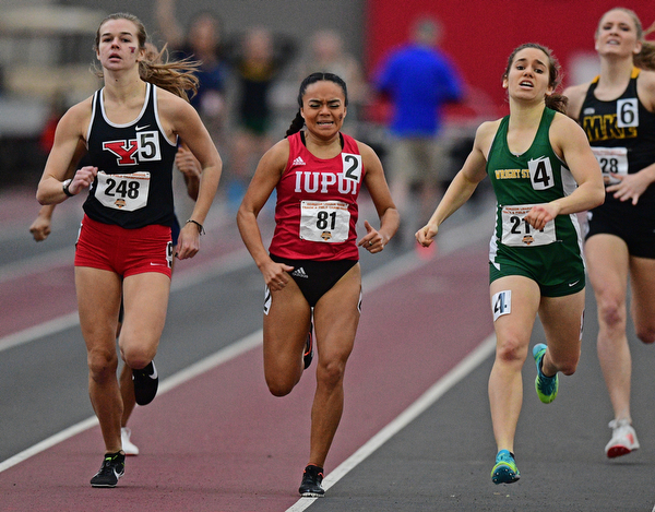 YOUNGSTOWN, OHIO - FEBRUARY 24, 2019: Youngstown State's Natalie Fleming, left, sprints to the finish line with IUPUI's Amairany Cruz, center, and Wright State's Vic Angelopoulos during the women's 800 meter dash final, Sunday afternoon at the Watt and Tressel Training Facility during the Horizon League Indoor Track Championship. DAVID DERMER | THE VINDICATOR