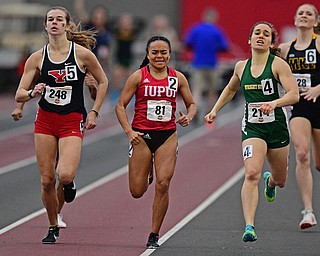 YOUNGSTOWN, OHIO - FEBRUARY 24, 2019: Youngstown State's Natalie Fleming, left, sprints to the finish line with IUPUI's Amairany Cruz, center, and Wright State's Vic Angelopoulos during the women's 800 meter dash final, Sunday afternoon at the Watt and Tressel Training Facility during the Horizon League Indoor Track Championship. DAVID DERMER | THE VINDICATOR