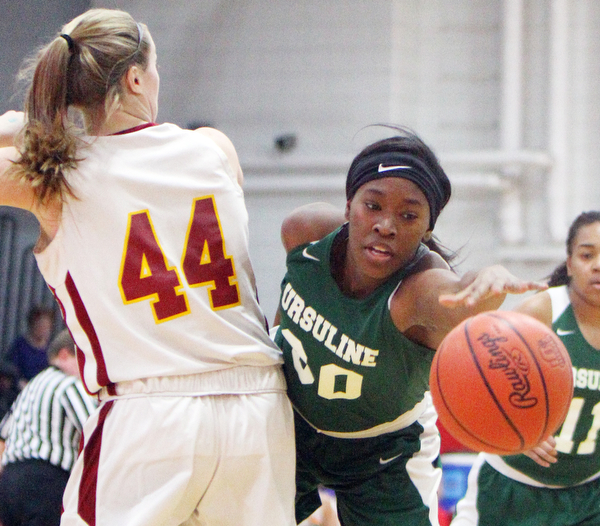 William D.Lewis The Vindicator  Ursuline's Anyah Curd(30) reaches for the ball past Mooney's Caitlin Perry(44).