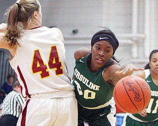 William D.Lewis The Vindicator  Ursuline's Anyah Curd(30) reaches for the ball past Mooney's Caitlin Perry(44).