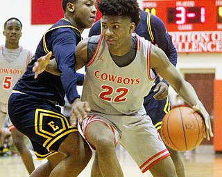 William D. Leiws The Vindicator Chaney's Quincey Jopnes(22) drives around East's Carl Sadler(13) during 1rst half action 2-26-19 at Chaney.