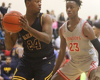 William D. Leiws The Vindicator  East's Gabriel Green(24) passes around Chaney's William Brown(23) during 1rst half action 2-26-19 at Chaney.