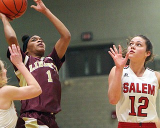 William D. Lewis The Vindicator Liberty's Sharda Williamson(1)  shots around Salem's Ellie Davidson(12 during 2-27-19 action at Struthers.