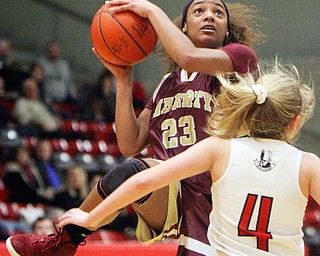 William D. Lewis The Vindicator Liberty's Nysa Gilchrist(23)  shoots over Salem's Casey Johnson(4) during 2-27-19 action at Struthers.