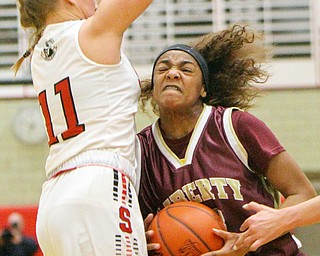 William D. Lewis The Vindicator Liberty's Nysa Gilchrist(23)  drives around Salem's Annie Davidson(11) during 2-27-19 action at Struthers.