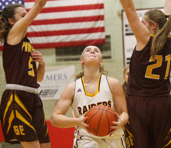 William D. Lewis The VindicatorSouth Range's Bree Kohler(12) drives between South East'sHalle Morehead(5)and Andrea Radcliff(21) during 2-27-19 action at Struthers.