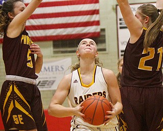 William D. Lewis The VindicatorSouth Range's Bree Kohler(12) drives between South East'sHalle Morehead(5)and Andrea Radcliff(21) during 2-27-19 action at Struthers.