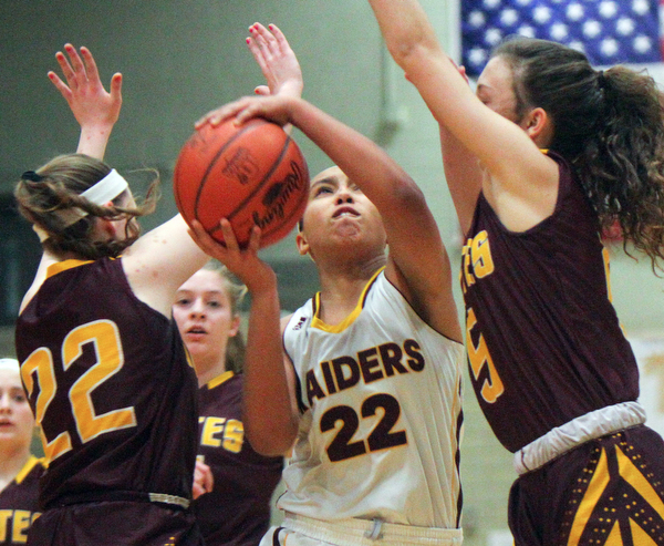 William D. Lewis The VindicatorSouth Range's Lexi Giles(22) drives between South East's Rachel Neer(22)and Halle Morehead(5) during 2-27-19 action at Struthers.