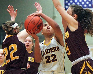 William D. Lewis The VindicatorSouth Range's Lexi Giles(22) drives between South East's Rachel Neer(22)and Halle Morehead(5) during 2-27-19 action at Struthers.