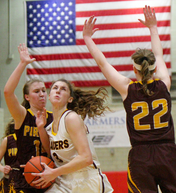William D. Lewis The VindicatorSouth Range's Izzy Lamparty(3)) drives between South East's Shelby Morehead(14) and Rachel Neer(22) during 2-27-19 action at Struthers.