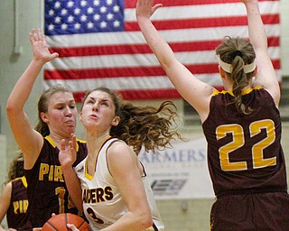 William D. Lewis The VindicatorSouth Range's Izzy Lamparty(3)) drives between South East's Shelby Morehead(14) and Rachel Neer(22) during 2-27-19 action at Struthers.