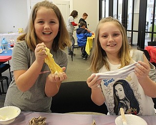 Neighbors | Abby Slanker.Sisters Olivia (left) and Gianna (right) strectched out their fluffy slime during the Canfield library’s Slime Time for Tweens on Jan .26.