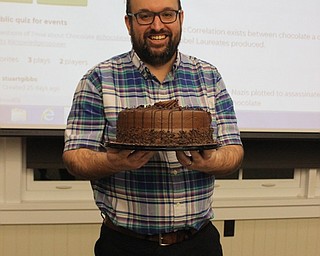Neighbors | Abby Slanker.Stuart Gibbs, adult librarian, celebrated Chocolate Cake Day at the Canfield library with a double layer chocolate cake on Jan. 28.