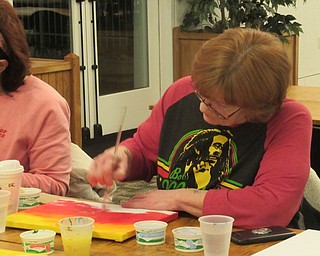 Neighbors | Jessica Harker.Community member Ginger Zink painted her canvas during the Art with Andrea event hosted on Feb. 11 at the Austintown library.