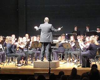 Neighbors | Jessica Harker.Poland High School band director Jeff Hvizdos conducted the school's symphonic band while they performed in the Winter Band Concert on Feb. 21.