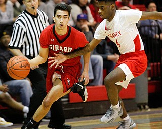 Girard's Austin Claussell drives the ball while Chaney's Ryan Clark tries to block him during their game at Chaney High School on Friday night. EMILY MATTHEWS | THE VINDICATOR