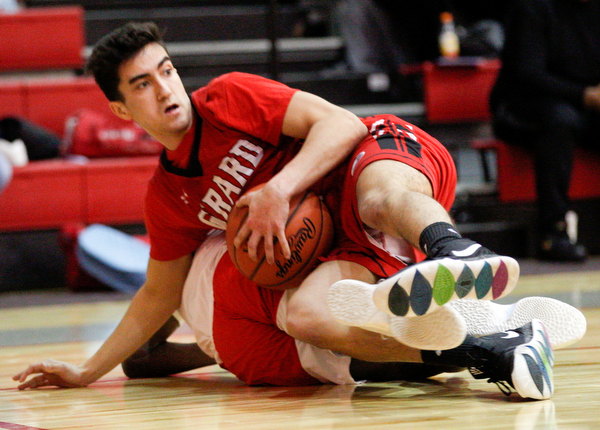 Girard's Austin Claussell tries to hold onto the ball while he and Chaney's Jamison Tubbs fall to the ground during their game at Chaney High School on Friday night. EMILY MATTHEWS | THE VINDICATOR