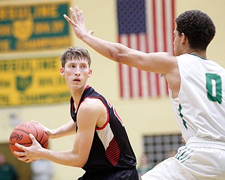 Canfield's Kyle Gamble looks to pass the ball while Ursuline's Devan Keevey tries to block him during their game at Ursuline on Friday night. EMILY MATTHEWS | THE VINDICATOR