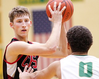 Canfield's Kyle Gamble looks to pass the ball while Ursuline's Devan Keevey tries to block him during their game at Ursuline on Friday night. EMILY MATTHEWS | THE VINDICATOR