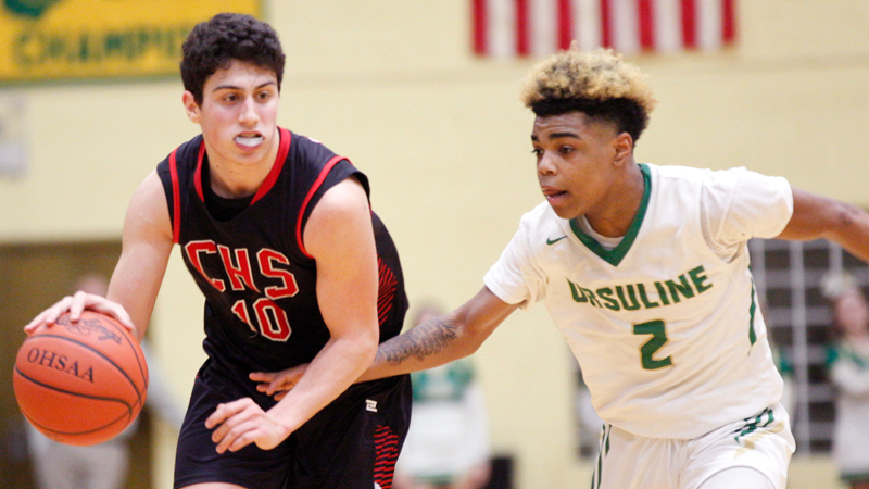 Canfield's Conor Crogan drives the ball while Ursuline's Daysean Harris tries to block him during their game at Ursuline High School on Friday night. 
