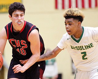 Canfield's Conor Crogan drives the ball while Ursuline's Daysean Harris tries to block him during their game at Ursuline High School on Friday night. 