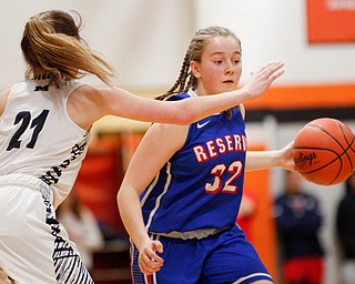 Western Reserve's Alyssa Serensky drives the ball while McDonald's Maddy Howard tries to block her during their game at Mineral Ridge High School on Saturday afternoon. EMILY MATTHEWS | THE VINDICATOR