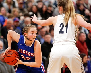 Western Reserve's Alyssa Serensky looks to pass the ball while McDonald's Maddy Howard tries to block her during their game at Mineral Ridge High School on Saturday afternoon. EMILY MATTHEWS | THE VINDICATOR