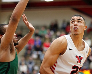 YSU's Noe Anabir looks towards the hoop while CSU's Algevon Eichelberger tries to block him during their game on Saturday night. EMILY MATTHEWS | THE VINDICATOR