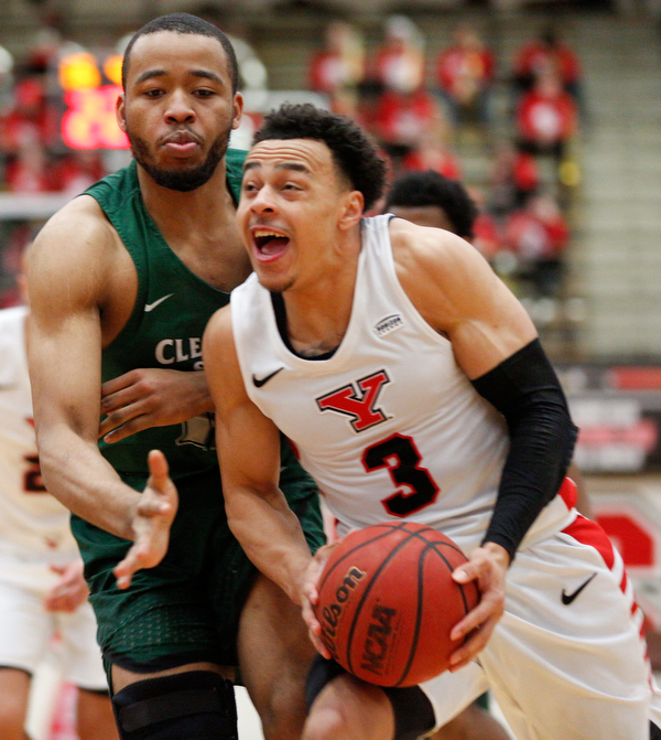 YSU's Darius Quisenberry drives the ball while CSU's Algevon Eichelberger tries to block him during their game on Saturday night. EMILY MATTHEWS | THE VINDICATOR