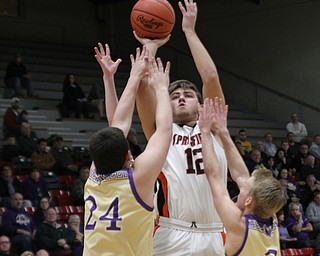 Shane Eynon (12) of Springfield gets double covered as he attempts a jump shot by Sebring’s Gabe Lanzer (24) and Joey Clark (3) during  the first half of Monday nights district matchup at Struthers High School. Dustin Livesay  |  The Vindicator  3/4/19  Struthers.