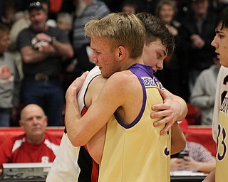Springfield’s Beau Brungard (left) consoles an emotional Sebring’s Joey Clark at the conclusion of Monday nights district matchup at Struthers High School. Dustin Livesay  |  The Vindicator  3/4/19  Struthers.