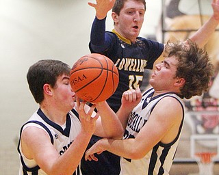 William D. Lewis The Vindicator  Lowellville's Jake Rotz(15) and McDonald's Jake Portolese(40) and Ryan Scala(22) go for a rebound.