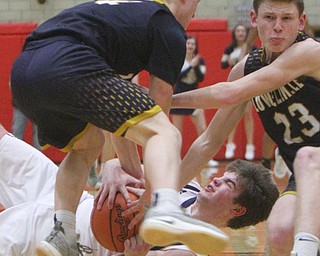 William D. Lewis The Vindicator  McDonald's Jake Portolese(400 keeps the ball from Lowellvilles Matt Hvidsak(14) and Cole Bunofsky(23).