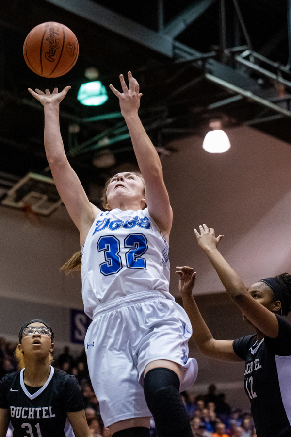 DIANNA OATRIDGE | THE VINDICATOR  Poland's Morgan Kluchar (32) puts up a shot between Akron Buchtel defenders Amiyah Stallings (31) and Kanai Chance (12) during the Division II Girls Regional Semi-final in Barberton on Tuesday.