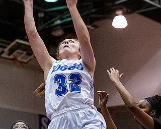 DIANNA OATRIDGE | THE VINDICATOR  Poland's Morgan Kluchar (32) puts up a shot between Akron Buchtel defenders Amiyah Stallings (31) and Kanai Chance (12) during the Division II Girls Regional Semi-final in Barberton on Tuesday.