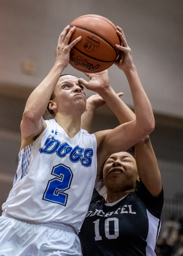 DIANNA OATRIDGE | THE VINDICATOR  Poland's Sarah Bury (2) drives to the basket as Akron Buchtel's Imani Jackson (10) defends during the Division II Girls Regional Semi-final in Barberton on Tuesday.