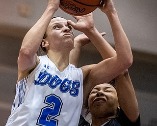 DIANNA OATRIDGE | THE VINDICATOR  Poland's Sarah Bury (2) drives to the basket as Akron Buchtel's Imani Jackson (10) defends during the Division II Girls Regional Semi-final in Barberton on Tuesday.