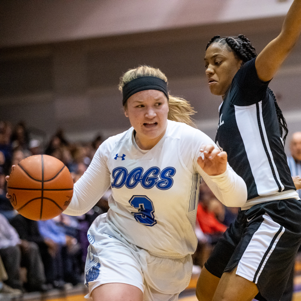 DIANNA OATRIDGE | THE VINDICATOR  Poland's Mia Gajdos (3) drives around Akron Buchtel's LaDhavion Duncan during the Division II Girls Regional Semi-final in Barberton on Tuesday.