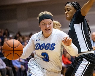 DIANNA OATRIDGE | THE VINDICATOR  Poland's Mia Gajdos (3) drives around Akron Buchtel's LaDhavion Duncan during the Division II Girls Regional Semi-final in Barberton on Tuesday.