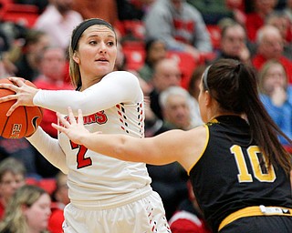 YSU's Alison Smolinski looks to pass the ball while Milwaukee's Jamie Reit tries to block her during their game at Beeghly Center on Wednesday night. EMILY MATTHEWS | THE VINDICATOR