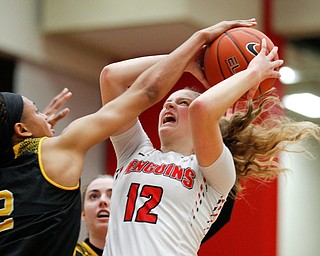 YSU's Chelsea Olson tries to shoot the ball while Milwaukee's Akaylah Hayes tries to block her during their game at Beeghly Center on Wednesday night. EMILY MATTHEWS | THE VINDICATOR