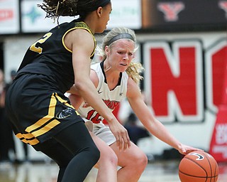 YSU's Melinda Trimmer drives the ball while Milwaukee's Akaylah Hayes tries to block her during their game at Beeghly Center on Wednesday night. EMILY MATTHEWS | THE VINDICATOR