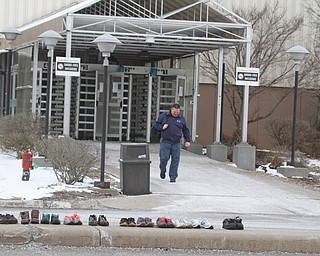  ROBERT K.YOSAY  | THE VINDICATOR..GM Lordstown finished the last Cruze at the plant Wed Afternoon. Putting thousands out of work ..some workers left their work shoes on the curb as they exited the plant - one of the last gm workers leaves the plant